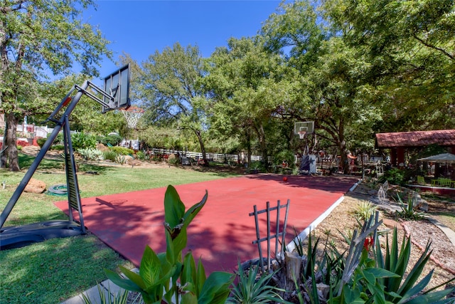 view of basketball court with a lawn