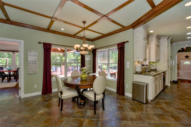 dining area featuring a healthy amount of sunlight, crown molding, and sink