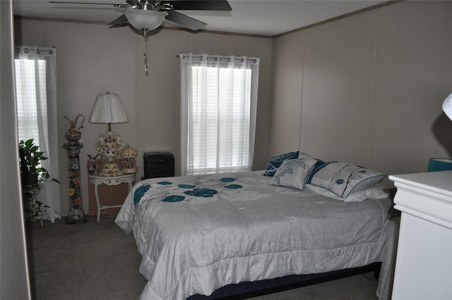 carpeted bedroom featuring crown molding and ceiling fan