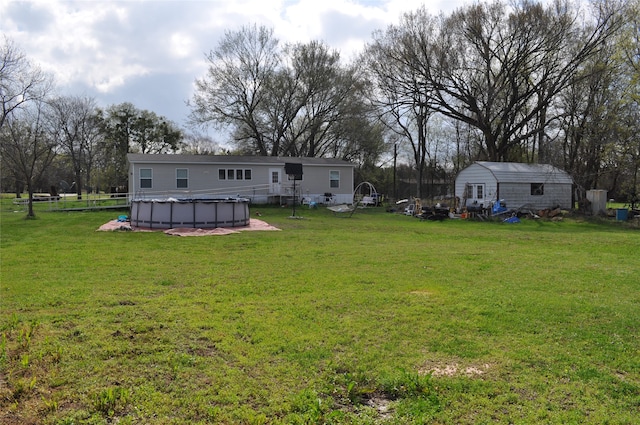 view of yard with a covered pool