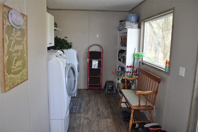 laundry area featuring dark wood-type flooring, cabinets, and separate washer and dryer