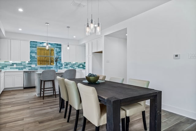 dining space with hardwood / wood-style flooring