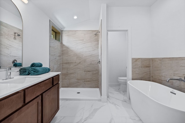 full bathroom featuring vanity, toilet, plus walk in shower, tile walls, and vaulted ceiling