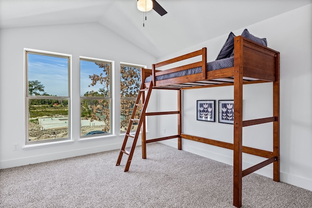 unfurnished bedroom with ceiling fan, vaulted ceiling, and carpet