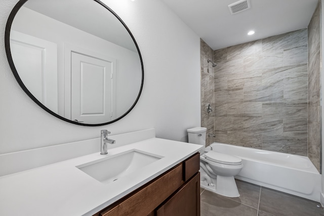 full bathroom with tiled shower / bath combo, tile patterned floors, vanity, and toilet