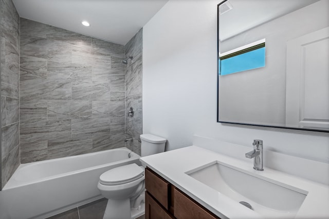 full bathroom with tile patterned floors, toilet, vanity, and tiled shower / bath