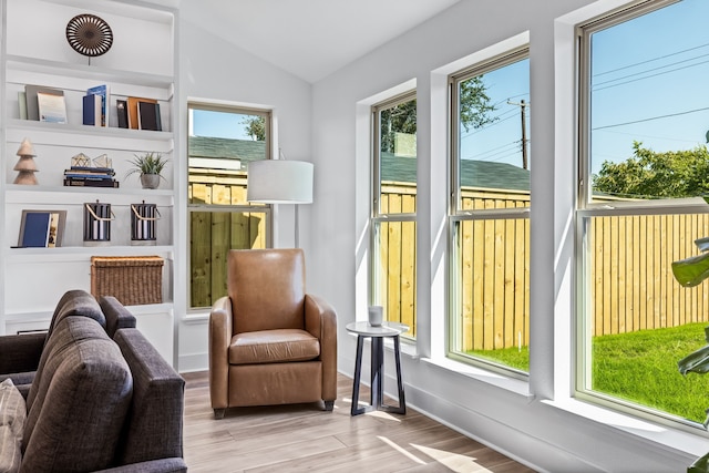 sitting room featuring lofted ceiling and light hardwood / wood-style flooring