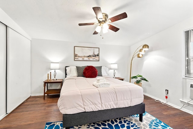 bedroom featuring ceiling fan, a closet, and dark hardwood / wood-style flooring