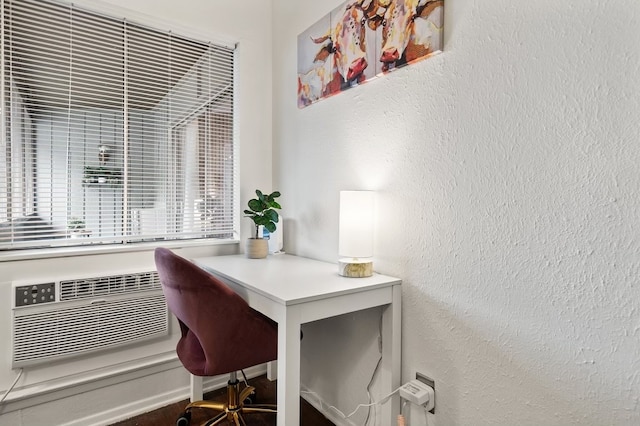 home office with built in desk and a wall mounted AC