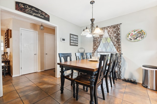 tiled dining area with a chandelier