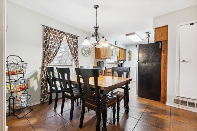 dining area featuring a chandelier and a wealth of natural light