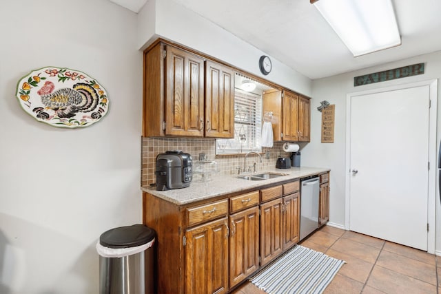 kitchen with dishwasher, decorative backsplash, sink, and light tile patterned floors