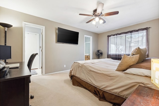 carpeted bedroom featuring ceiling fan and ensuite bath