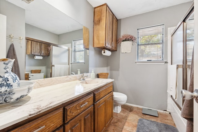 full bathroom featuring shower / bath combination with glass door, toilet, tile patterned flooring, and vanity