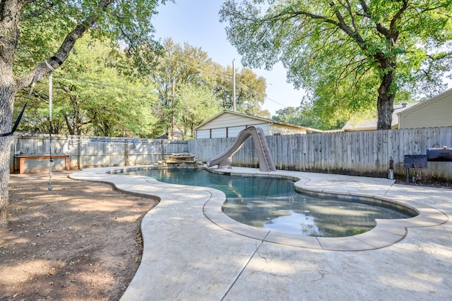 view of swimming pool with a patio and a water slide