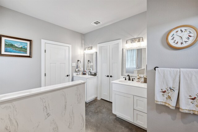 bathroom featuring vanity and concrete floors