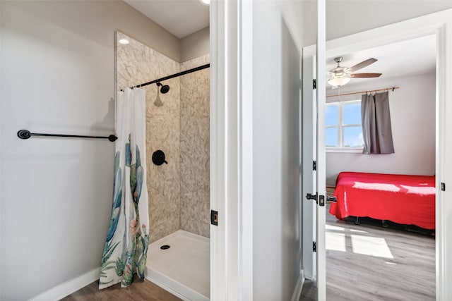 bathroom with hardwood / wood-style flooring, ceiling fan, and walk in shower