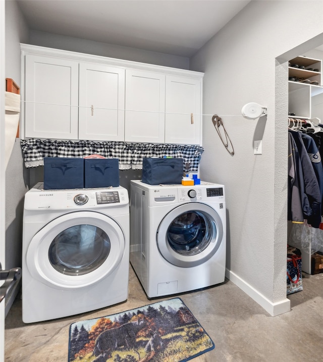 washroom featuring cabinets and washing machine and dryer