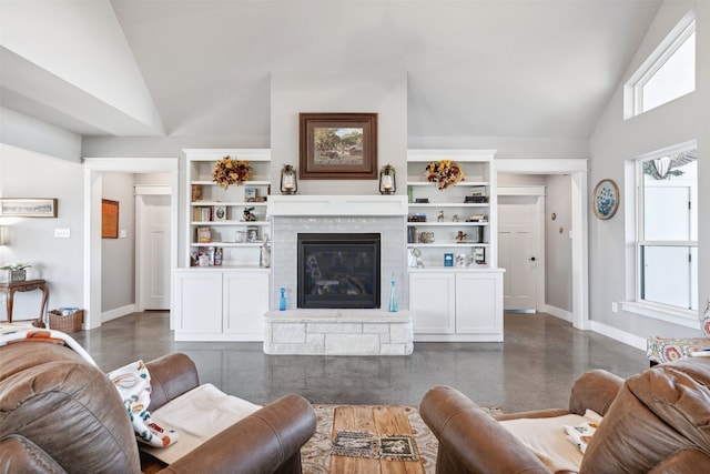 living room with high vaulted ceiling, a fireplace, and built in shelves