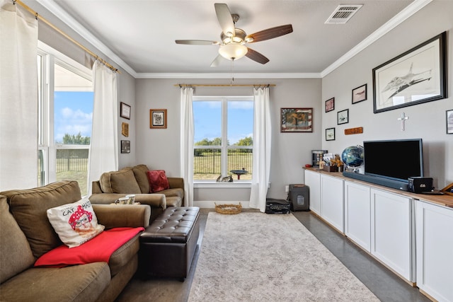 living room with ornamental molding and ceiling fan