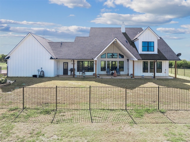 modern inspired farmhouse featuring a front lawn