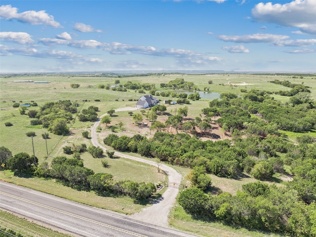 birds eye view of property featuring a water view and a rural view