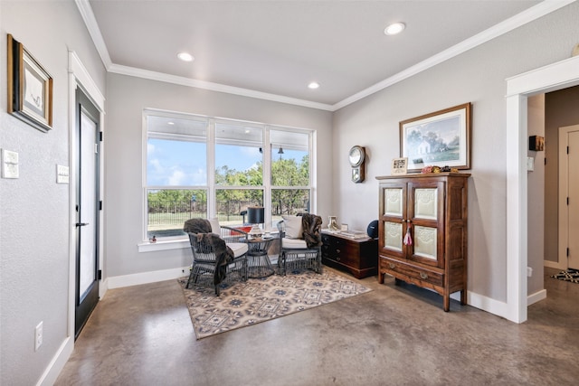 sitting room with crown molding and concrete flooring