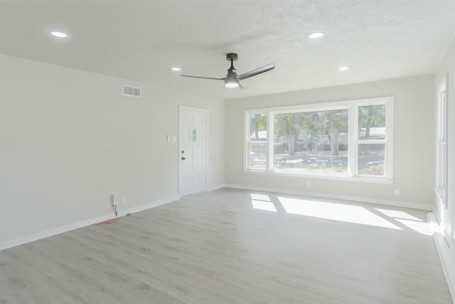 spare room featuring light hardwood / wood-style flooring and ceiling fan