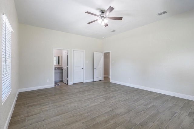 unfurnished bedroom with multiple windows, light wood-type flooring, and ceiling fan