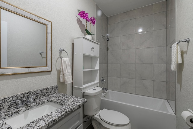 full bathroom featuring vanity, toilet, and tiled shower / bath combo