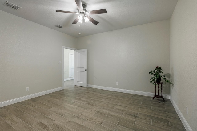 unfurnished room featuring hardwood / wood-style floors, a textured ceiling, and ceiling fan