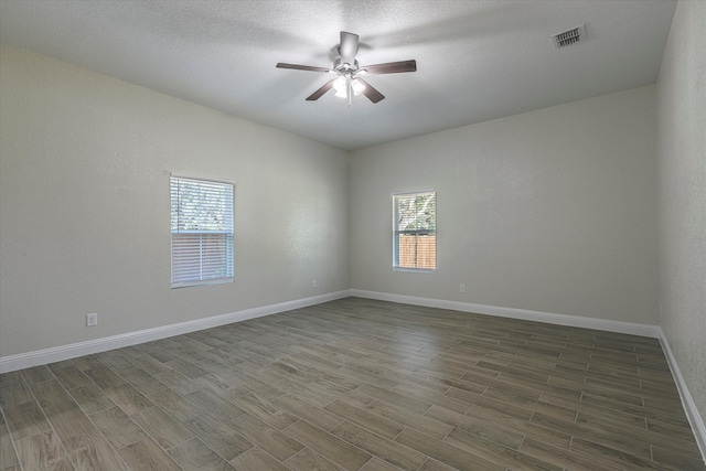 spare room with wood-type flooring, a textured ceiling, and ceiling fan