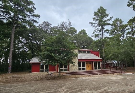 rear view of property featuring a wooden deck