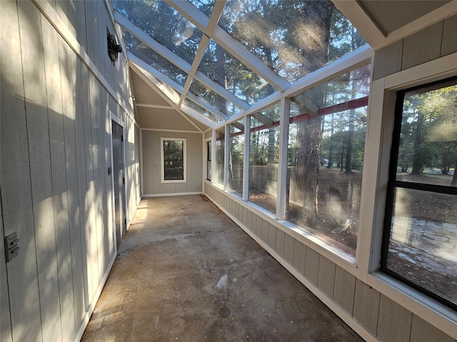 unfurnished sunroom featuring lofted ceiling and a healthy amount of sunlight