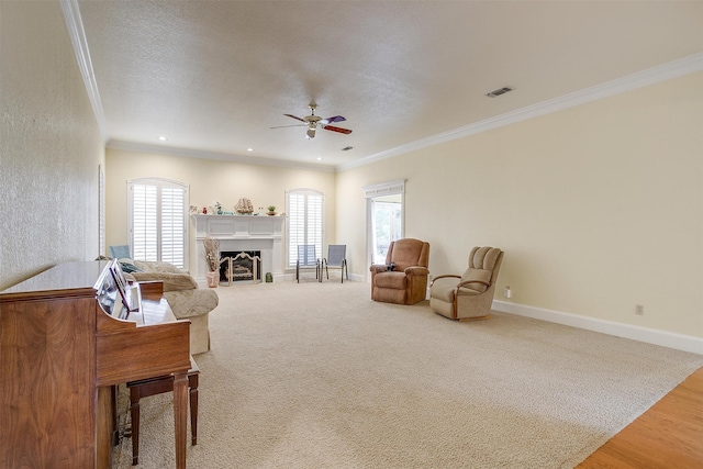 living room with ornamental molding, a healthy amount of sunlight, and a textured ceiling