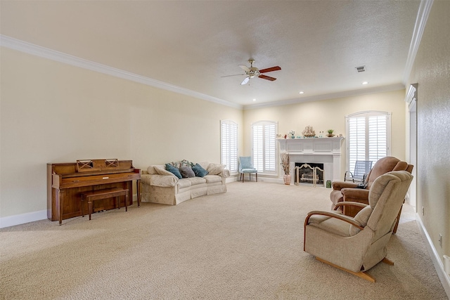 living room featuring light carpet, ornamental molding, a textured ceiling, and ceiling fan