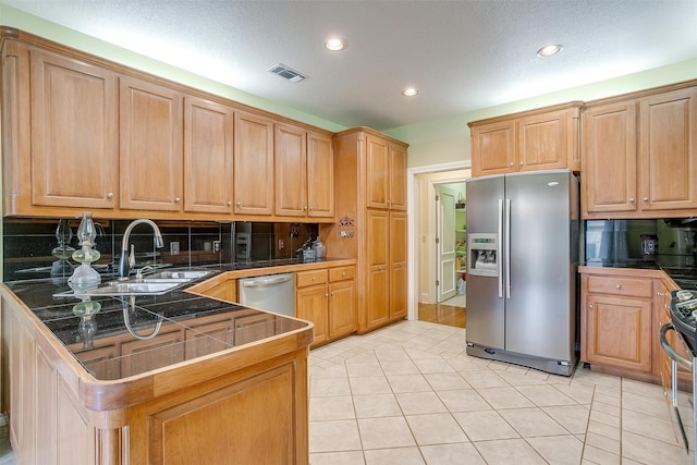 kitchen featuring appliances with stainless steel finishes, kitchen peninsula, and a textured ceiling