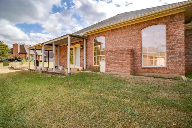 view of front of property with a patio area and a front lawn