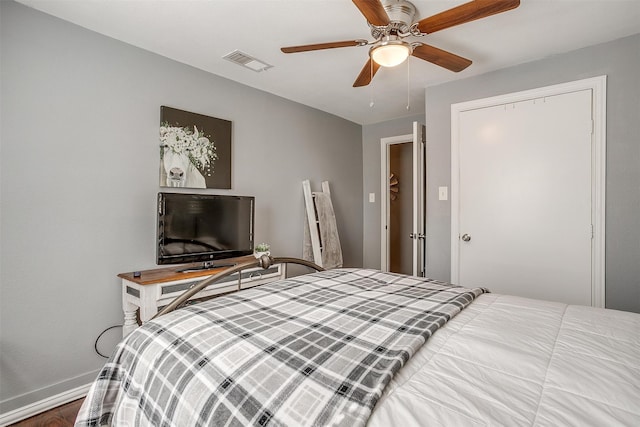 bedroom with wood-type flooring, ceiling fan, and a closet