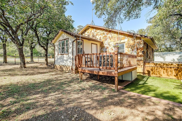 back of property with a wooden deck