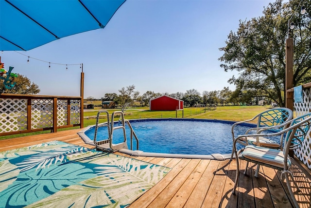 view of pool featuring a wooden deck and a yard