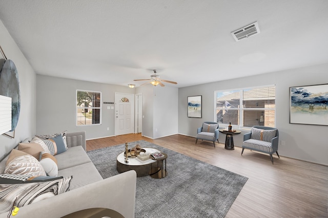 living room featuring hardwood / wood-style floors and ceiling fan