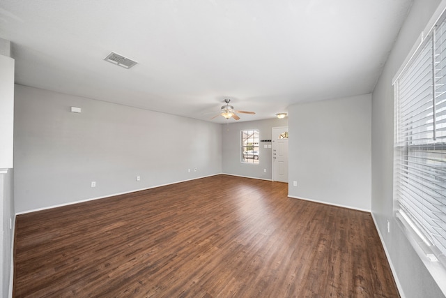 spare room featuring dark hardwood / wood-style floors and ceiling fan