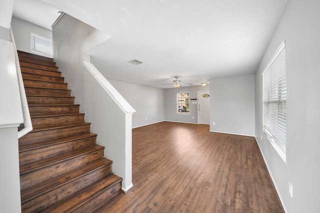 interior space with a wealth of natural light, dark hardwood / wood-style floors, and ceiling fan