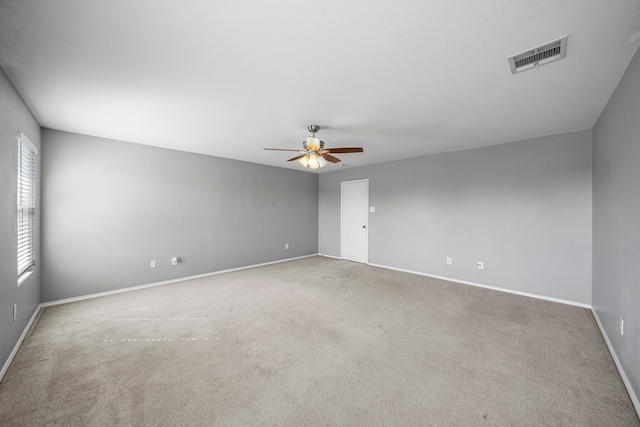 empty room featuring light colored carpet and ceiling fan