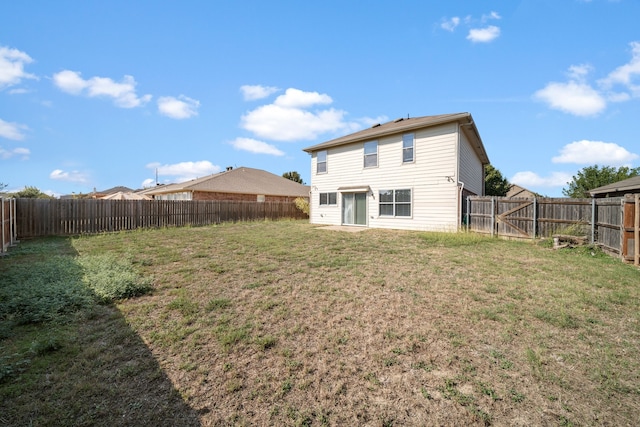 back of house with a yard