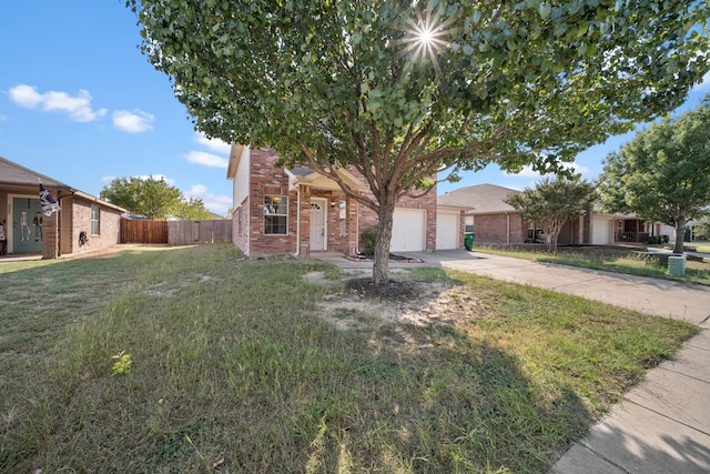 view of property hidden behind natural elements featuring a front yard and a garage