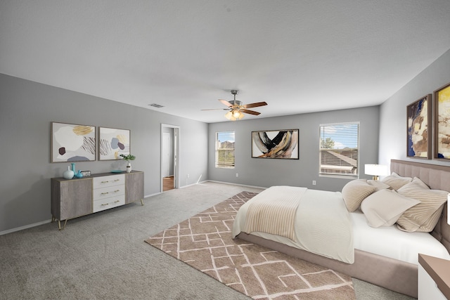 carpeted bedroom with ceiling fan