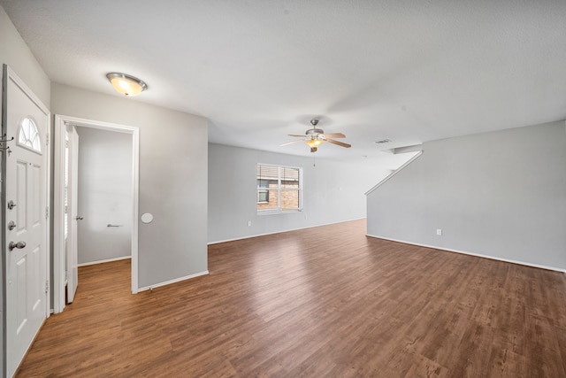 interior space featuring ceiling fan, a textured ceiling, and dark hardwood / wood-style floors