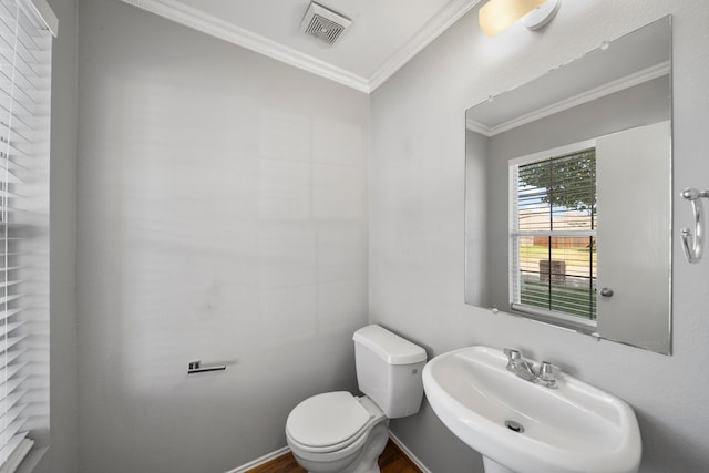 bathroom featuring toilet, crown molding, hardwood / wood-style flooring, and sink